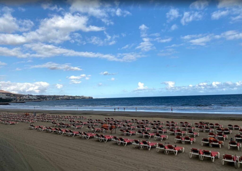 All Inclusive Family Holidays to Gran Canaria | brown sand beach with red beach seats