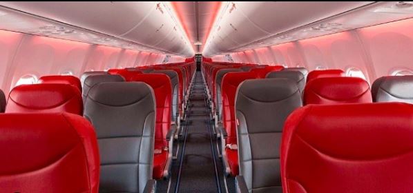 Cheap Holidays to Gran Canaria| inside an aircraft red and black seats